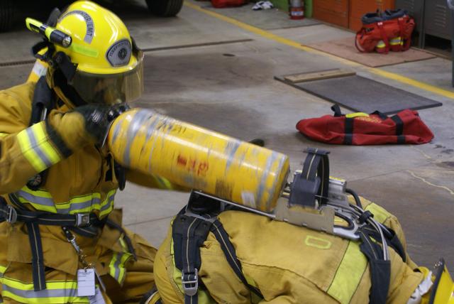 Damon Jacobs conducts an emergency air bottle exchange for Ross Dubarry during firefighter 1 drill at the Paul Smiths Gabriels Fire Station 10/16/2010